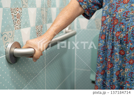 Asian elderly woman patient use toilet bathroom handle security in nursing hospital, healthy strong medical. Asian elderly woman patient use toilet bathroom handle security in nursing hospital, healthy strong medical. 137184714