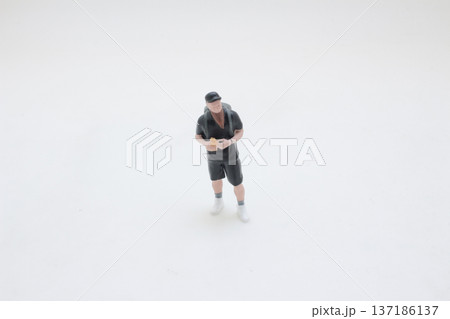 Miniature Figure Stands Upright With Arms Firmly Crossed Miniature Figure Stands Upright With Arms Firmly Crossed 137186137