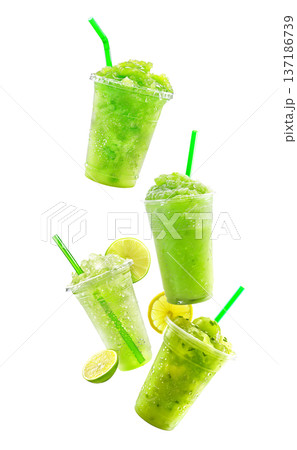 Green lime slush drinks in plastic cups, isolated on white background, expressing cool summer freshness 137186739