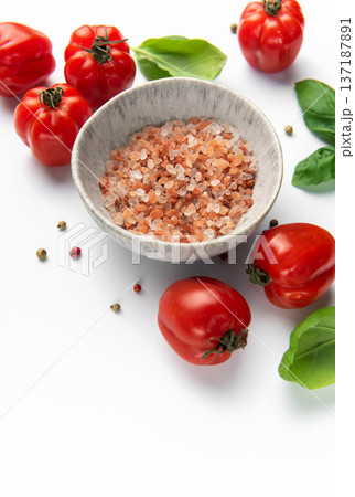 Himalayan pink salt, fresh tomatoes, and basil leaves on white background 137187891