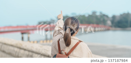 Woman tourist sightseeing Fukuura jima bridge or the bridge of romantic encounters for Fukuura Island at Matsushima Bay in Matsushima, Miyagi Prefecture, Tohoku, Japan. Landmark and famous Vacation 137187984