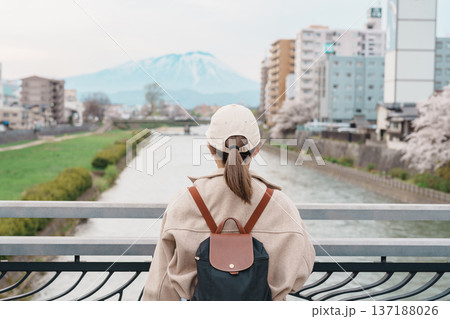 Woman tourist sightseeing Iwate mountain and Kitakami river with flowers in Spring, happy traveler travel in Morioka city, Iwate prefecture, Japan. famous Landmark Travel and Vacation destination Woman tourist sightseeing Iwate mountain and Kitakami river with flowers in Spring, happy traveler travel in Morioka city, Iwate prefecture, Japan. famous Landmark Travel and Vacation destination 137188026