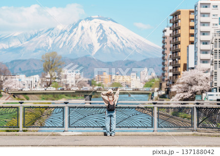Woman tourist sightseeing Iwate mountain and Kitakami river with flowers in Spring, happy traveler travel in Morioka city, Iwate prefecture, Japan. famous Landmark Travel and Vacation destination Woman tourist sightseeing Iwate mountain and Kitakami river with flowers in Spring, happy traveler travel in Morioka city, Iwate prefecture, Japan. famous Landmark Travel and Vacation destination 137188042