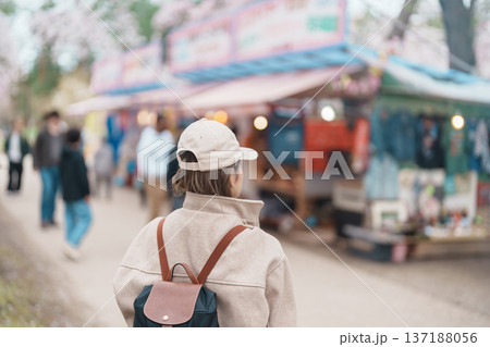 Woman tourist sightseeing Hirosaki Castle park with Sakura Cherry Blossom in Spring, traveler travel in Hirosaki city, Aomori, Tohoku, Japan. Landmark famous in Japan. Travel and Vacation destination 137188056