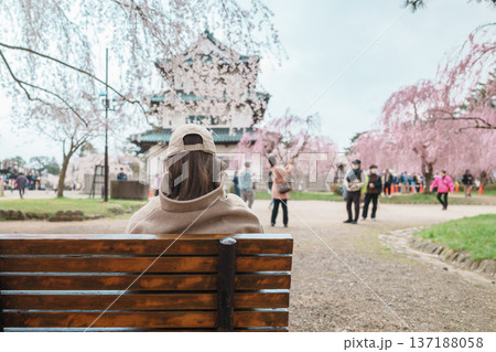 Woman tourist sightseeing Hirosaki Castle with Sakura Cherry Blossom in Spring, happy traveler travel in Hirosaki city, Aomori, Tohoku, Japan. Landmark famous in Japan. Travel and Vacation destination 137188058