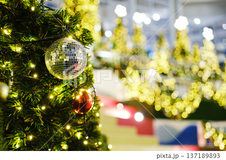 Christmas tree adorned with sparkling ornaments and lights, creating a festive atmosphere, ideal for New Years greeting cards with copy space for personalized messages Christmas tree adorned with sparkling ornaments and lights, creating a festive atmosphere, ideal for New Years greeting cards with copy space for personalized messages 137189893