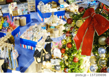 Aerial view of a vibrant tropical shopping mall interior adorned with festive Christmas decorations, showcasing colorful merchandise and a lively atmosphere for holiday shopping 137189896
