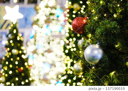 Christmas tree adorned with colorful ornaments and twinkling lights, creating a festive atmosphere for holiday celebrations and New Year greetings with copy space for text Christmas tree adorned with colorful ornaments and twinkling lights, creating a festive atmosphere for holiday celebrations and New Year greetings with copy space for text 137190010