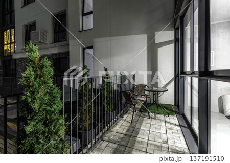 Modern Apartment Balcony with Night Lighting and Outdoor Furniture Modern Apartment Balcony with Night Lighting and Outdoor Furniture 137191510