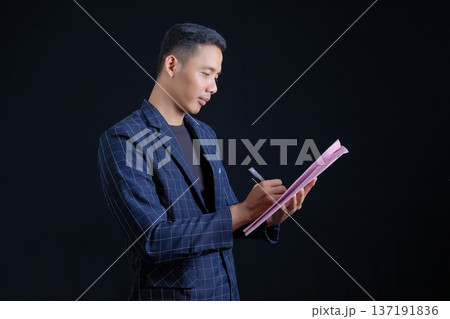 Portrait of handsome elegant man in black suit on black background. Studio mode portrait Portrait of handsome elegant man in black suit on black background. Studio mode portrait 137191836