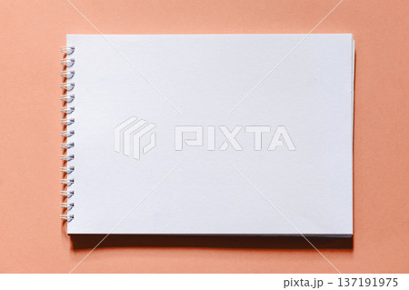 Blank spiral sketchbook on a bright background - top view Blank spiral sketchbook on a bright background - top view 137191975