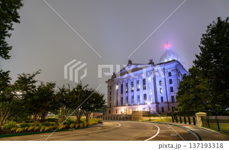 Scenic night view of the illuminated classical facade and dome of the Oklahoma State Capitol building surrounded by dense fog in Oklahoma City. 137193318