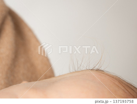 Close-up shot of soft newborn hair lit by gentle natural light. Neutral tones and minimal composition create a clean, calm aesthetic perfect for parenting, maternity, baby care, and lifestyle themes Close-up shot of soft newborn hair lit by gentle natural light. Neutral tones and minimal composition create a clean, calm aesthetic perfect for parenting, maternity, baby care, and lifestyle themes 137193758