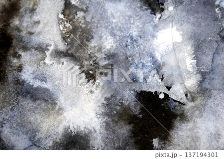 Abstract black and grey watercolour paint and ink swirling on white paper background to look like clouds and monochrome wash 137194301