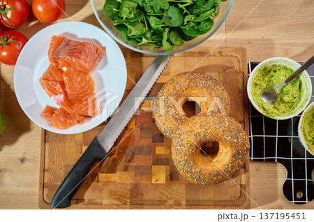 Top view breakfast ingredients with bagels salmon avocado spread and spinach 137195451