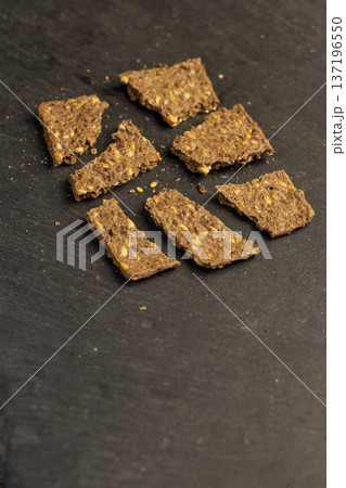 thin natural hard dry rye flour loaves with flax seeds and wheat fiber, natural loaves from a complex of ingredients for dietary nutrition 137196550