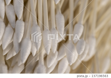 cotton swabs made of natural cotton and sticks made of recycled paper, sticks with pieces of natural cotton wool for personal hygiene and facial care 137196563