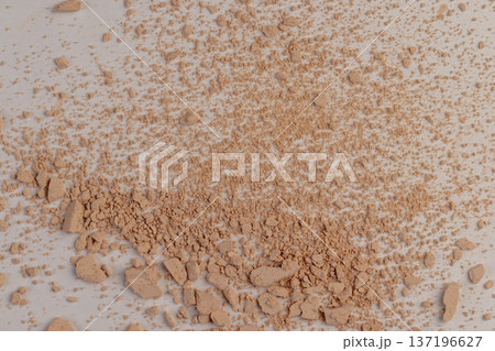 scattered broken cosmetics, makeup powder , dust and small and large pieces of women's cosmetics that were broken and ruined, cosmetics are scattered on paper scattered broken cosmetics, makeup powder , dust and small and large pieces of women's cosmetics that were broken and ruined, cosmetics are scattered on paper 137196627
