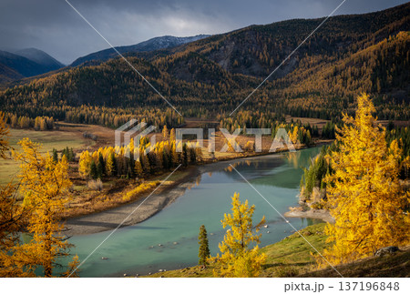 Serene autumn landscape with a turquoise river surrounded by forested mountains Serene autumn landscape with a turquoise river surrounded by forested mountains 137196848
