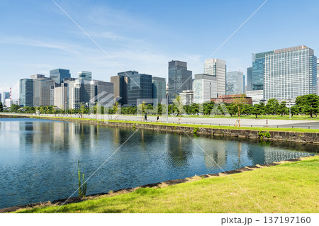View of the Kokyo moat with the Marunouchi Modern office building in Chiyoda, Tokyo, Japan. Marunouchi is the core of the Tokyo central business district. View of the Kokyo moat with the Marunouchi Modern office building in Chiyoda, Tokyo, Japan. Marunouchi is the core of the Tokyo central business district. 137197160