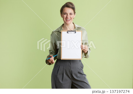 Smiling professional presenting blank clipboard 137197274