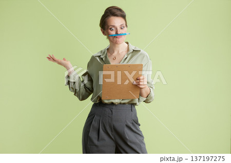 Playful businesswoman with pen 137197275