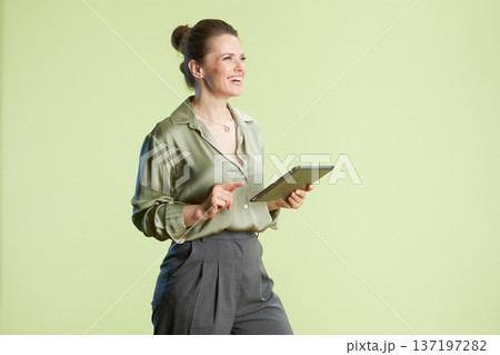 Green blouse, tablet in studio 137197282