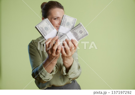 Hidden smile: Woman with stacks of hundred dollar bills Hidden smile: Woman with stacks of hundred dollar bills 137197292