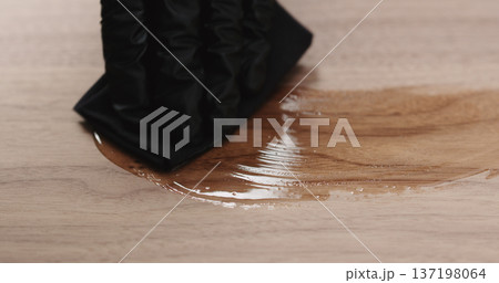 woodworker applying oil finish to black walnut board 137198064