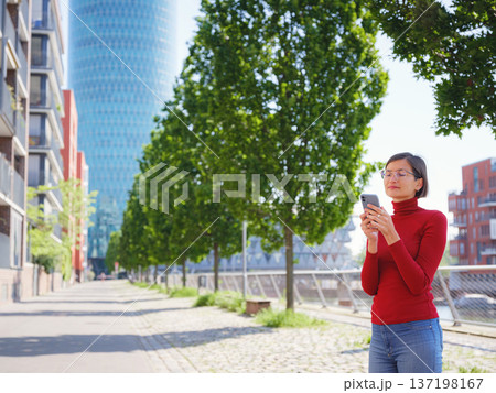 Woman in glasses stands in center of Frankfurt, Woman in glasses stands in center of Frankfurt, 137198167