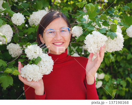 Woman in glasses stands in center of Frankfurt, 137198168
