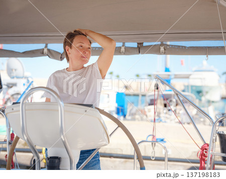 Woman Captain Steering Yacht Wheel Maneuvering From Marina Woman Captain Steering Yacht Wheel Maneuvering From Marina 137198183