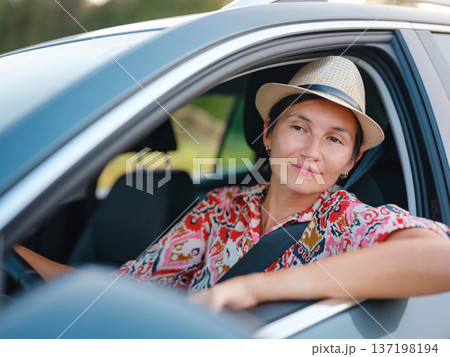 Traveler woman drives car through scenic countryside of Croatia Traveler woman drives car through scenic countryside of Croatia 137198194