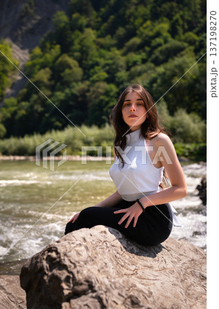 Natural Portrait of a Young Woman by a Mountain River 137198270