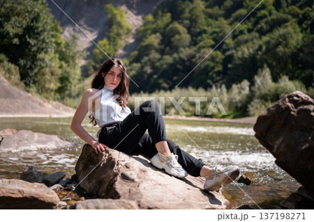 Natural Portrait of a Young Woman by a Mountain River 137198271