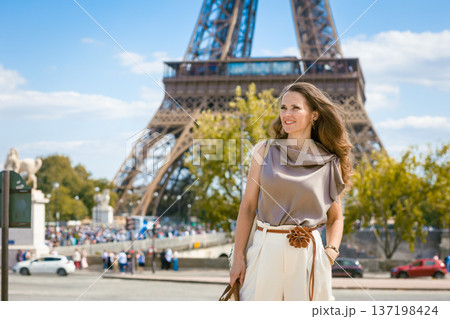 Stylish Traveler Poses by the Eiffel Tower in Paris Stylish Traveler Poses by the Eiffel Tower in Paris 137198424