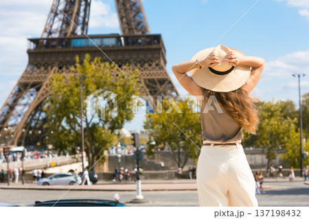 Woman Gazing at Eiffel Tower from Behind 137198432
