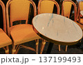Traditional Paris cafe terrace with rattan chairs and a classic marble table, representing European city life and travel 137199493