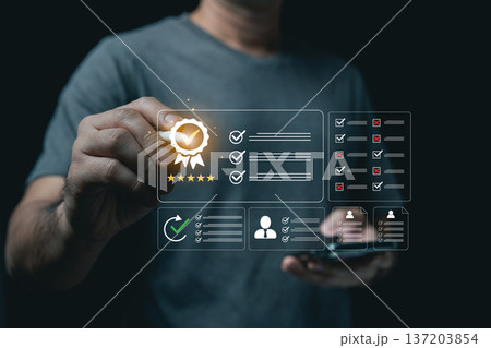 Man using digital pen to evaluate virtual quality assurance badge and checklists on dark background Man using digital pen to evaluate virtual quality assurance badge and checklists on dark background 137203854