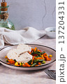 Boiled chicken fillet and mixed vegetables on a plate on the table vertical view 137204331