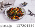 Buckwheat soba noodles with vegetables on a plate on the table 137204339