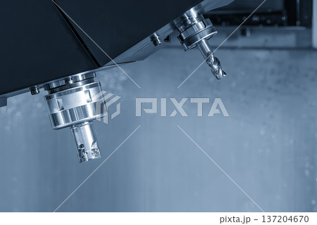 Close-up of an indexable face milling tool with carbide inserts installed in a CNC machining center's automatic tool changer (ATC) magazine. Close-up of an indexable face milling tool with carbide inserts installed in a CNC machining center's automatic tool changer (ATC) magazine. 137204670
