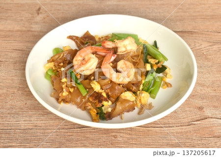 stir fried large rice noodles with shrimp and Chinese kale dressing black sweet soybean sauce on plate stir fried large rice noodles with shrimp and Chinese kale dressing black sweet soybean sauce on plate 137205617