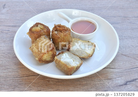 deep fried mashed crab meat roll dumpling Chinese food on plate dipping sweet plum sauce deep fried mashed crab meat roll dumpling Chinese food on plate dipping sweet plum sauce 137205829