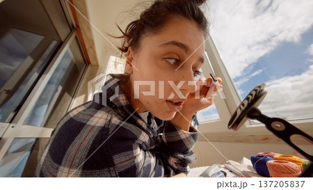 City resident applying mascara outside during morning rush 137205837