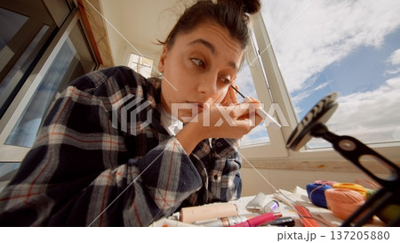 Rehearsal scene showing actress focusing on eye makeup application Rehearsal scene showing actress focusing on eye makeup application 137205880