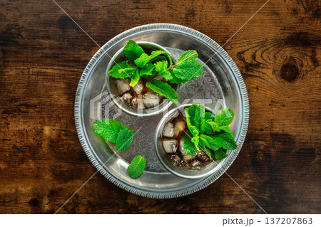 Mint Julep in the Kentucky Derby classic silver glass, with fresh mint leaves 137207863