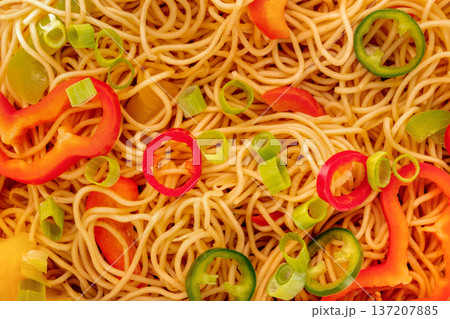 Hakka noodles with vegetables, peppers and green onions, overhead shot 137207885