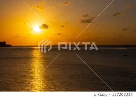 沖縄県国頭郡本部町渡久地　濱元橋から眺める水納島のシルエットに沈む夕陽 137208337