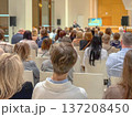 Audience seated in hall listening to speaker, business conference with screen. Education Workshop Session. Forum Presentation. Professional Networking Meeting. Corporate Training Seminar, training 137208450